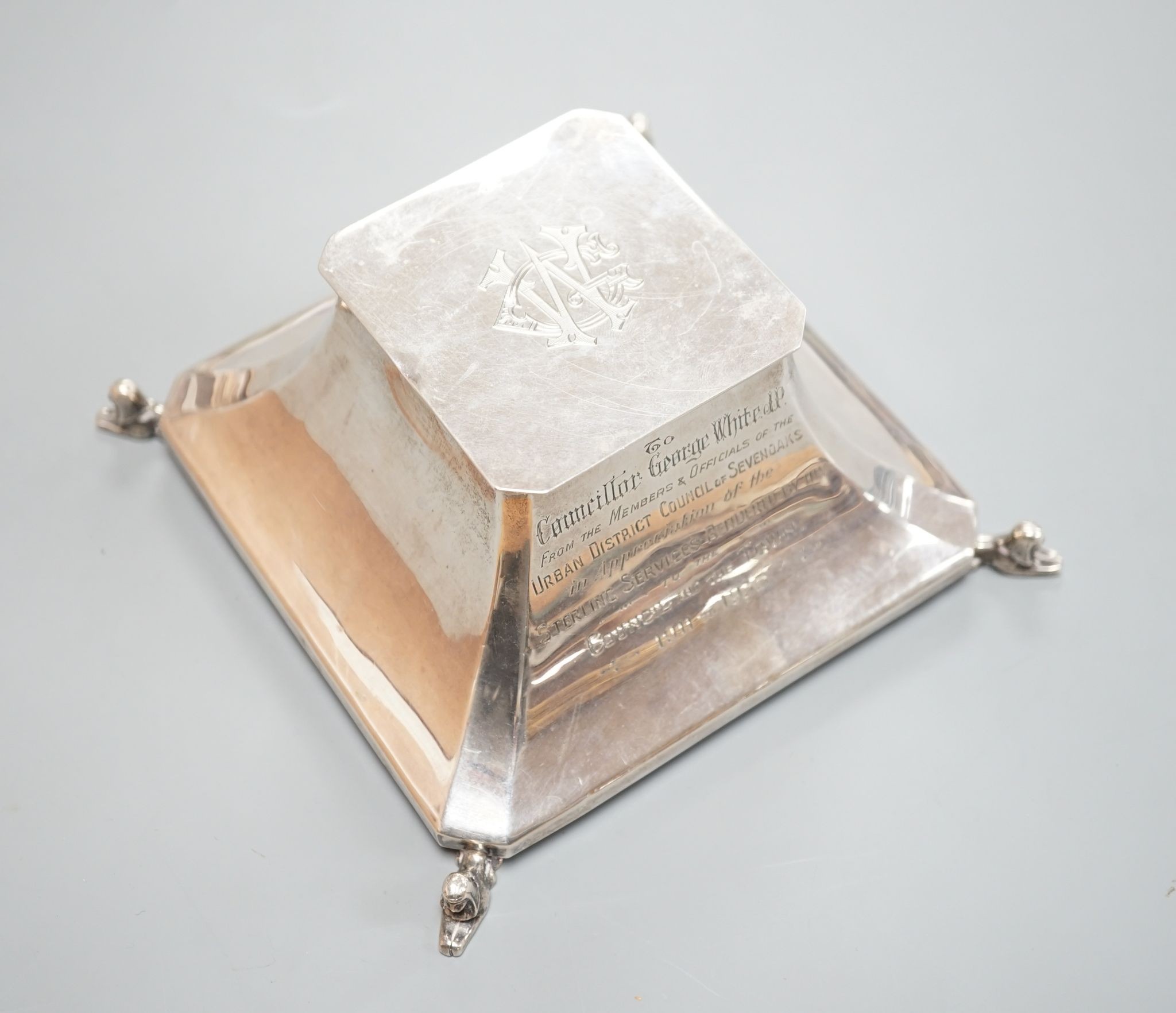 A George V silver mounted inkwell, Birmingham, 1924, with presentation inscription and monogram, 14.2cm.